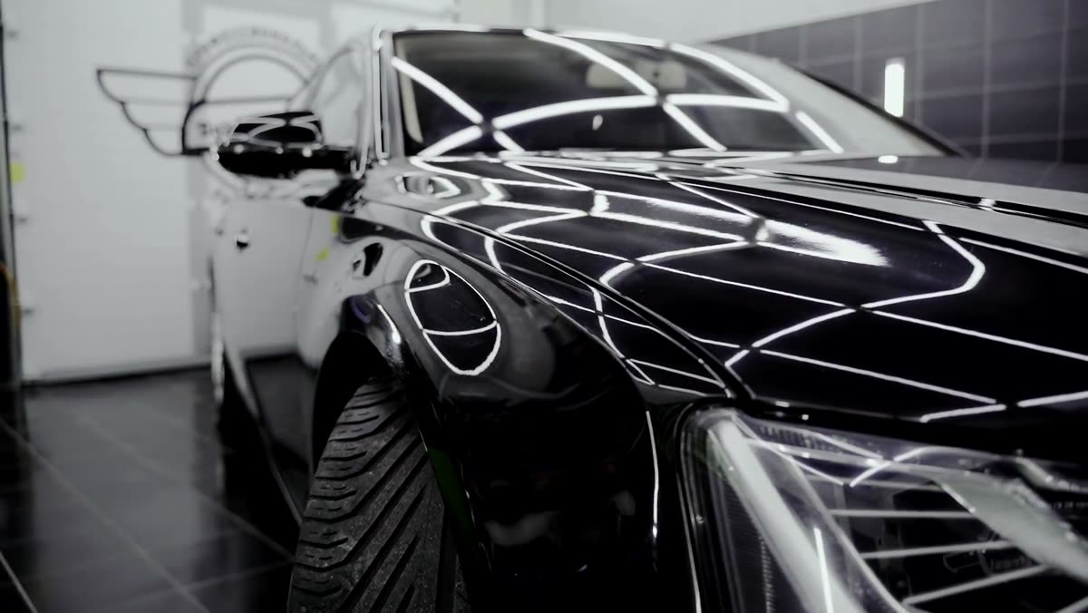 Finished black car gleaming under studio lights